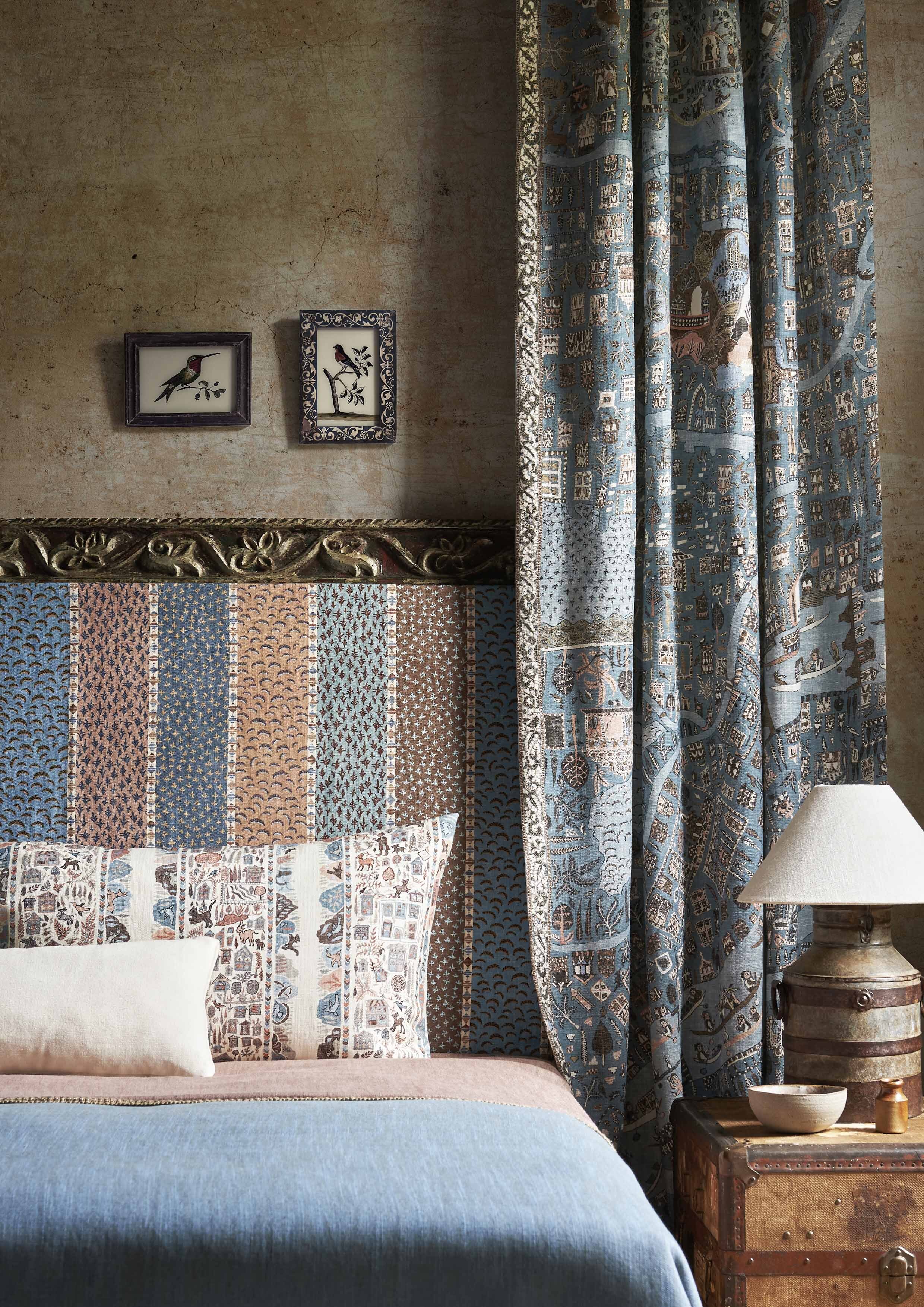 blue bedroom with striped headboard and map inspired curtain
